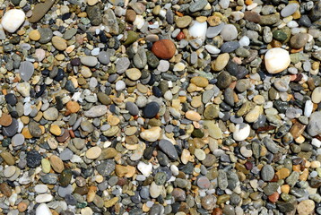 Wet round stones background, texture. pebble beach stones background seamless texture for design. Natural rounded gravel at sea shore Nature background texture pattern