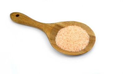 Himalayan salt in a wooden spoon isolated on white background