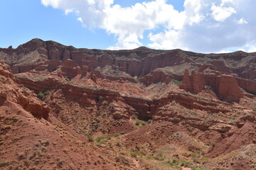 The red sandstone cliffs, canyons and valleys of Kyrgyzstan in Central Asia
