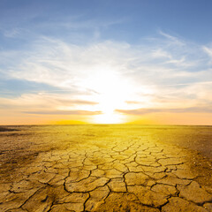 dry cracked earth at the dramatic sunset