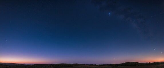 Obraz premium A tranquil twilight sky with stars appearing over the serene horizon, perfect for illustrating peaceful evenings, astronomy, and stargazing events