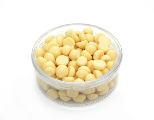 Organic cocoa butter buttons (wafers) isolated on white background
