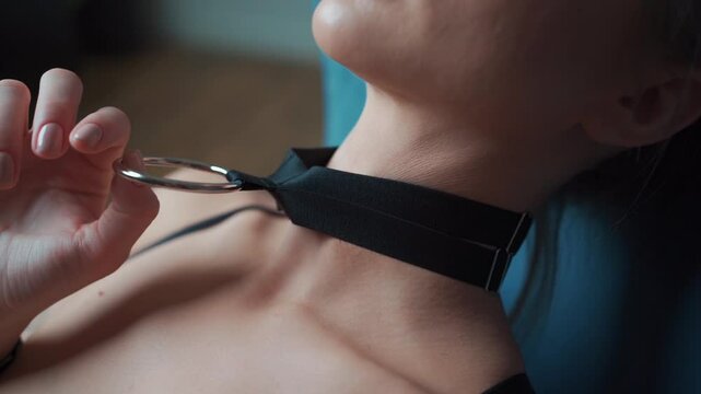 naked woman in black leather bdsm collar with metallic ring, nude female in seductive role playing game sexy choker