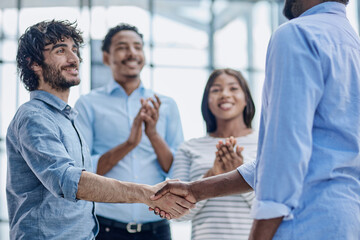 Obraz premium Successful Business Collaboration: Executives Greet with Handshake in Office