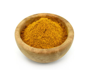 curry powder in a wooden bowl isolated on white background