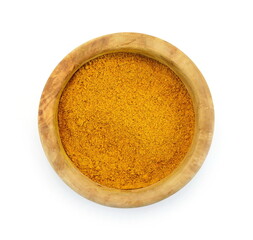 curry powder in a wooden bowl isolated on white background