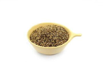 Cumin or caraway seeds in a bowl isolated on white background. 