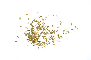 Fennel seeds spilled on a white background