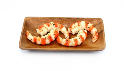 Cooked shrimps in a wooden bowl isolated on white background.