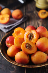 Fresh ripe apricots in bowl in rustic style