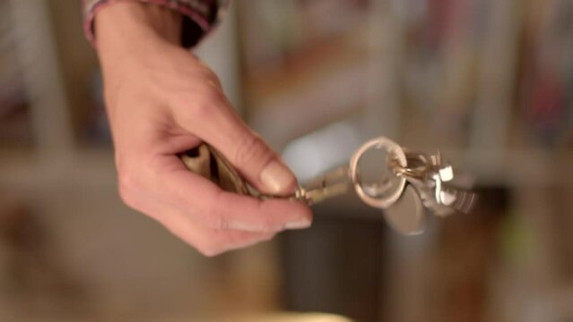 Visual Symbol of Access or Control Keys are used as a visual symbol representing power, control, or access to something important. Shaking a bunch of keys in the hands of a man.