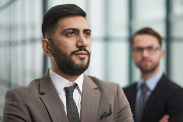 Fototapeta premium Portrait male worker looking at camera, positive employee posing for company business directory with co-workers