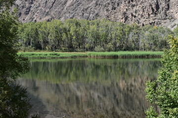 The stunning turquoise lake Iskanderkul and surrounding mountains and valleys in Tajikistan, Central Asia