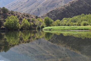 The stunning turquoise lake Iskanderkul and surrounding mountains and valleys in Tajikistan,...