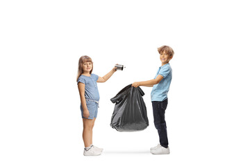 Boy holding a plastic waste bag and girl throwing a tin can