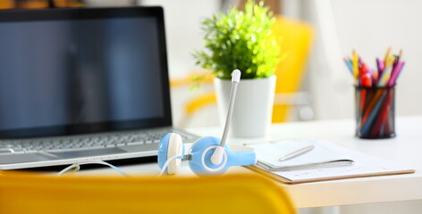 Empty remote office workplace with laptop pc and headset closeup. Receptionist or secretary of...