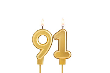 Golden number 91 birthday candle on white background