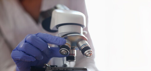 The head microscope on the background laboratory is a study human biology analyzes for non-compliance with the requirements organization public health at international level