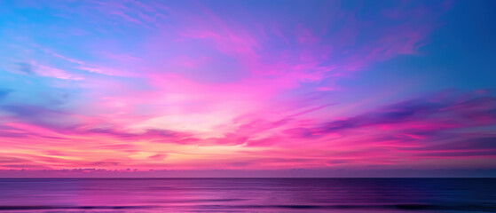 Fototapeta premium A beautiful sunset over the ocean with a pink and purple sky