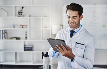 Happy, scientist and man with tablet in lab for research, data analytics and reading experiment test results. Male doctor, digital and online report, information and manufacturing medical vaccine
