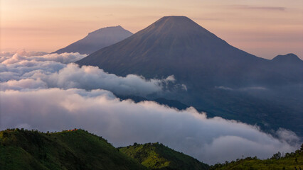 Fototapeta premium the beautiful view of volcanoes; Sindoro & Sumbing Volcanoes in Java Island during sunrise.