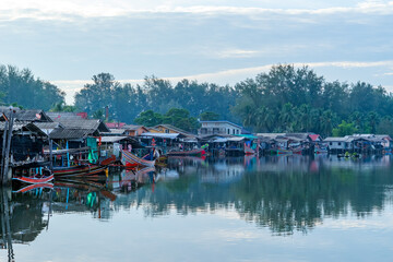 Obraz premium Sunset of Bang Nara River Village and Kolae boat of local fisherman at Narathiwat Province Southern of Thailand.