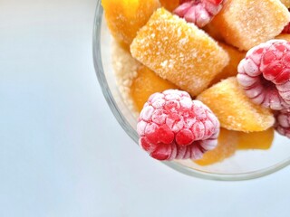 Frozen raspberries and mango cubes.