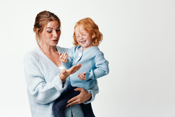 Mother and child embracing in front of a blank white background as a symbol of love and family bonding