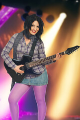 Fototapeta premium Woman Playing Guitar with Lights Background