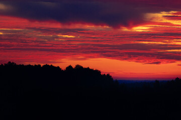 A beautiful minimalist landscape with colorful sunrise skies. Bright summer scenery of rural Latvia, Northern Europe.