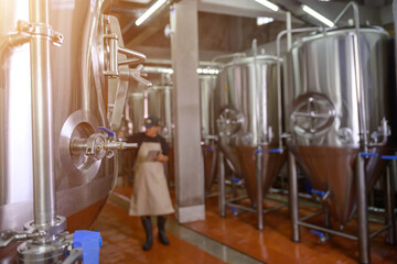 A Focus on the Beer-Brewing Tank Only Blurry photo after being in a brewery While evaluating the flavor and color of their beer, brewers assess the beer's quality. in the brewery industry