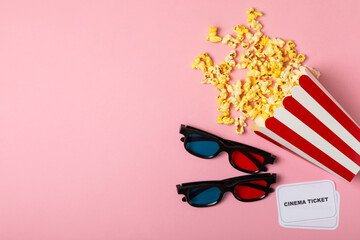 Tasty popcorn in buckets and cold cola drinks with cinema tickets, movie clapper and 3D eyeglasses...