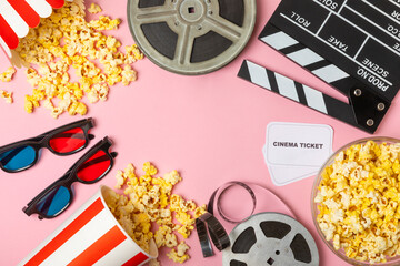 Tasty popcorn in buckets and cold cola drinks with cinema tickets, movie clapper and 3D eyeglasses...
