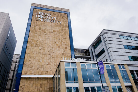 Leeds England: 3rd June 2024: Leeds Beckett University exterior Campus. Exterior wide angle with trees and Uni signage, purple banner