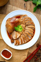 Stewed duck , steamed duck sliced on a white plate, top view food table, wooden background
