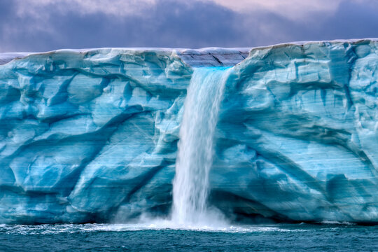 Waterfall caused by melt water, Austfonna Polar Ice Cap, Svalbard, Norway, Arctic Ocean. September, 2023. 