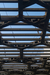 Engineering iron structure with many beams against blue sky background