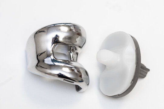 Set of orthopedic knee replacement implants on white background