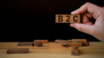Wooden cubes with with icons the letters B2B. B2B, business to business marketing symbol. Business and B2B concept. Wooden cubes table background.