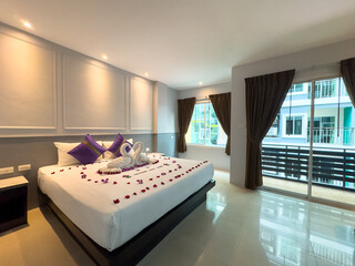 Hotel Room Decorated single double bedroom with nice white bed sheets purple decorative colours. the colour scheme is designed for thailand and interior is m modern classical