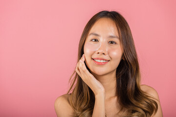 Eye skin treatment. Asian beautiful young woman smiling mask cosmetic patches gel under the eyes, Portrait female with natural makeup hydrogel eye patch on face, isolated on pink background, skincare