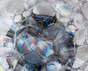 Abstract background with a mass of soap bubles with iridescent surfaces