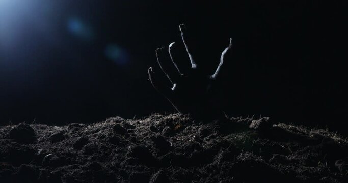 Zombie hand rising out from the ground
