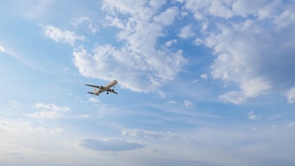 Airplane in the sky at sunset. Air transportation.  Travel. Airplane Takes Off Against the Background of Blue Sky. 