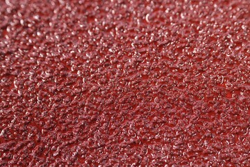 Fototapeta premium Texture of coarse sandpaper as background, closeup