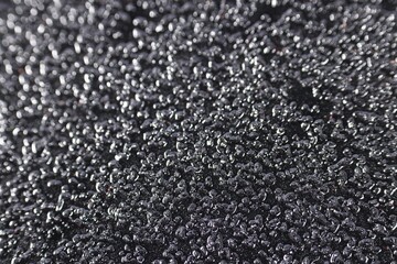 Texture of coarse sandpaper as background, closeup