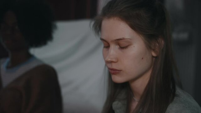 POV shot of looking at diverse girl friends while performing dark rituals in abandoned house at night. Lady drinking blood from ritual cup evoking evil spirits into living world