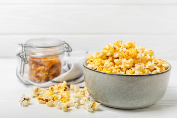 Tasty popcorn on wooden background. Cinema and entertainment concept. Movie night with popcorn.Cheese and caramel popcorn. Delicious appetizer, snack. Place for text. Copy space.Banner