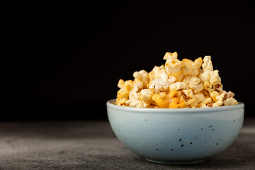 Tasty popcorn on wooden background. Cinema and entertainment concept. Movie night with popcorn.Cheese and caramel popcorn. Delicious appetizer, snack. Place for text. Copy space.Banner