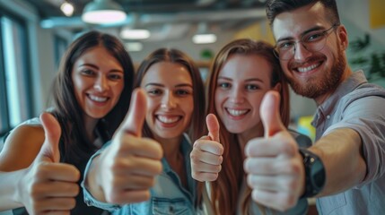 Group of happy successful entrepreneurs celebrating victory and showing thumbs up at office and looking at camera 